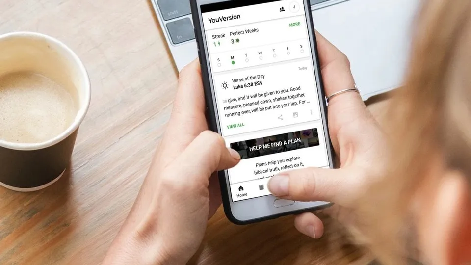 Someone using the Youversion Bible App on a Smartphone